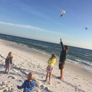 kids feeding seagulls on the beach in Destin