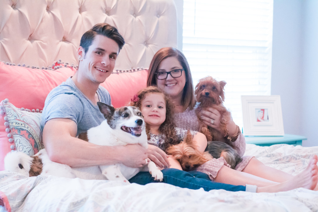 Family portrait with dogs on the bed