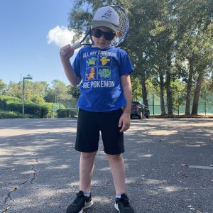 Issac with his tennis racket being cool