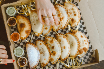 Empanadas Empanadas in a box with sauces.